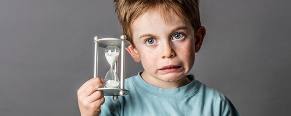 Kid holding an hour glass